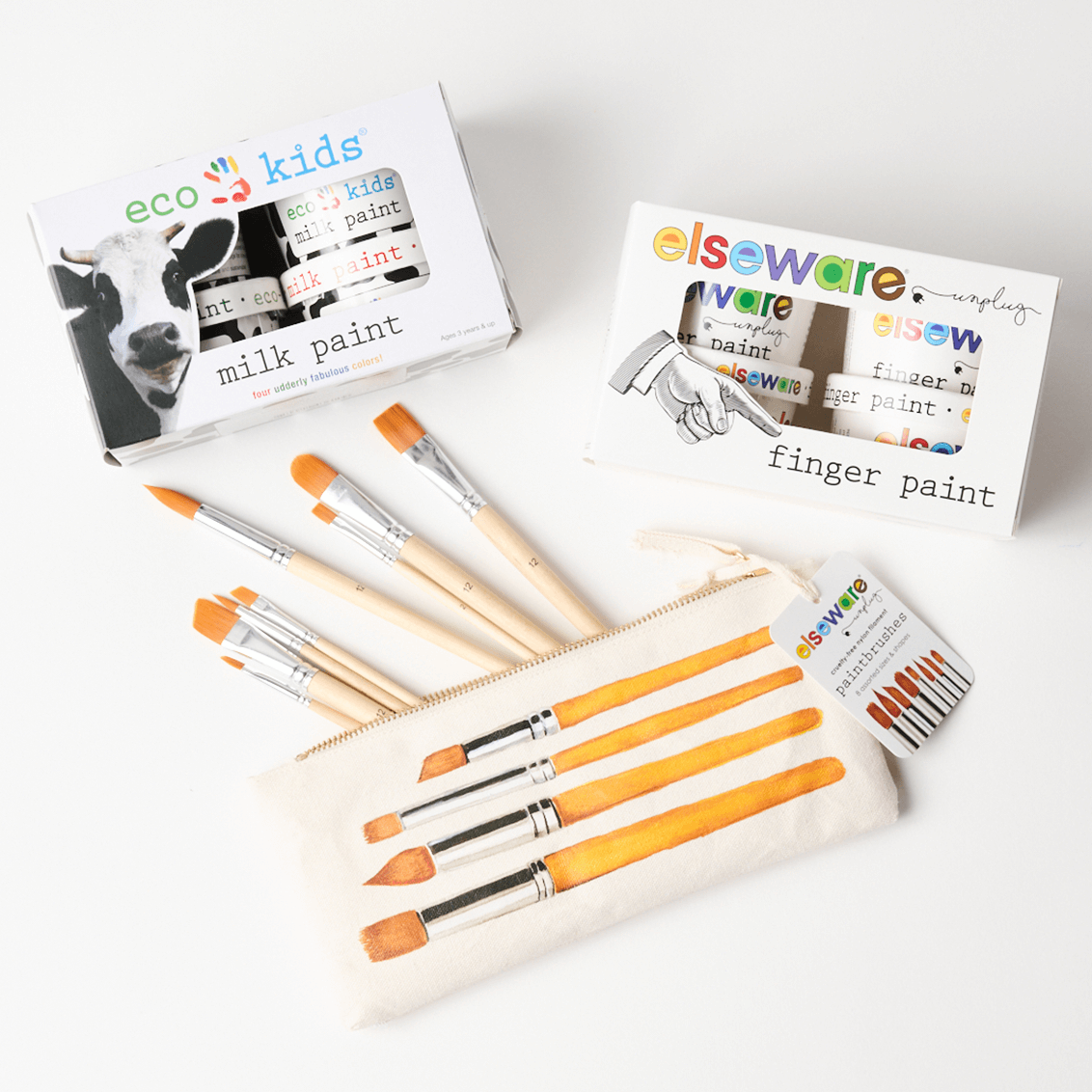 Set of paintbrushes with eco-kids milk paint and elseware finger paint packaging on a white background