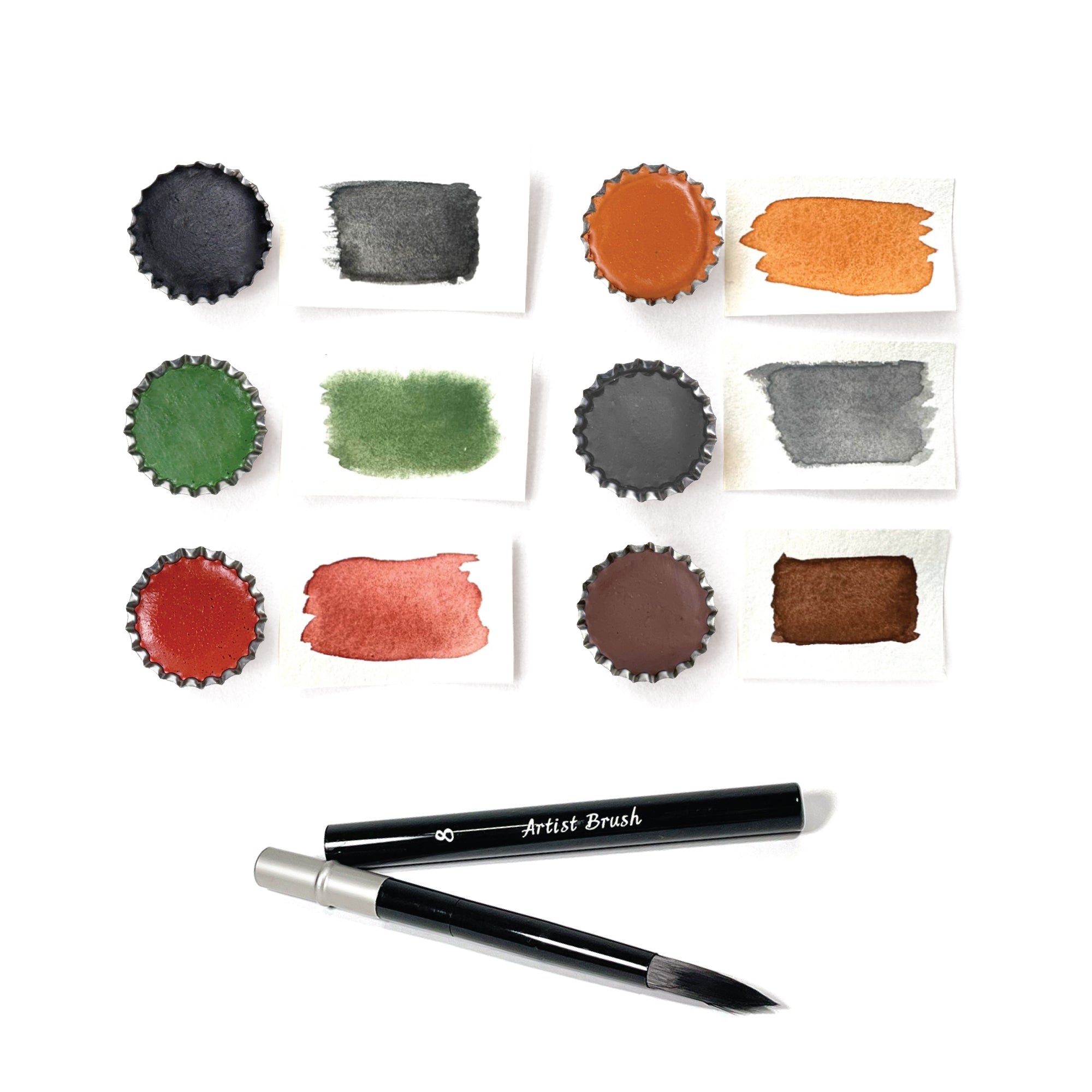 A set of Elseware Unplug handmade earth paints in six natural hues, created from soil, clay, and minerals. The rich, earthy pigments are displayed in small tin cups, with corresponding swatches of color painted on paper beside each. A sleek black artist brush with a detachable handle is included, making it easy to mix and apply the eco-friendly, hand-poured paints. These earth paints evoke a sense of grounding and creativity, perfect for mindful art-making and relaxation.