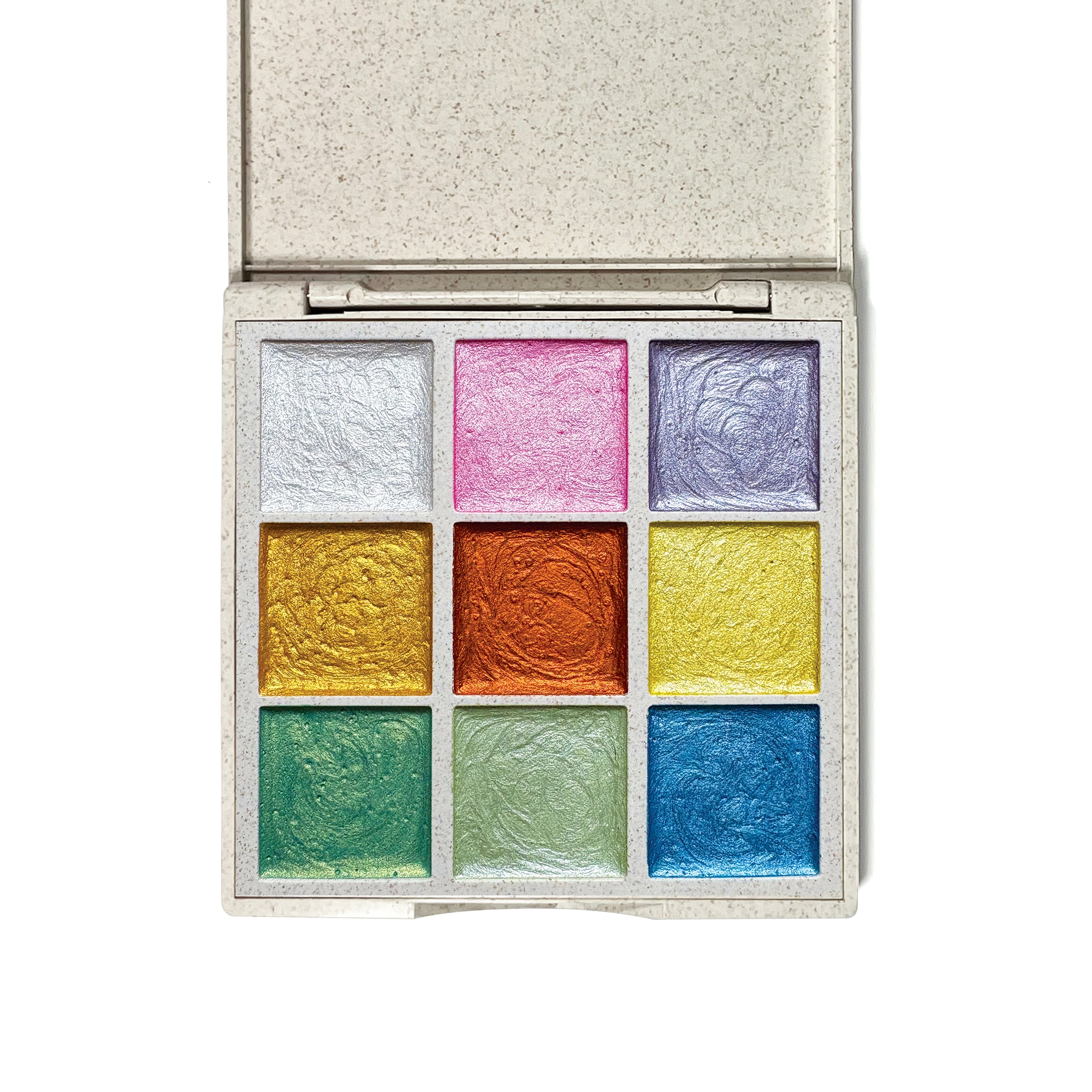 Open Elseware Unplug Metallic Watercolors palette showcasing nine shimmering pastel shades, including silver, pink, purple, gold, orange, yellow, green, and blue. Housed in a sustainable wheat straw bioplastic case, these hand-poured watercolors add a radiant sparkle to any artwork.