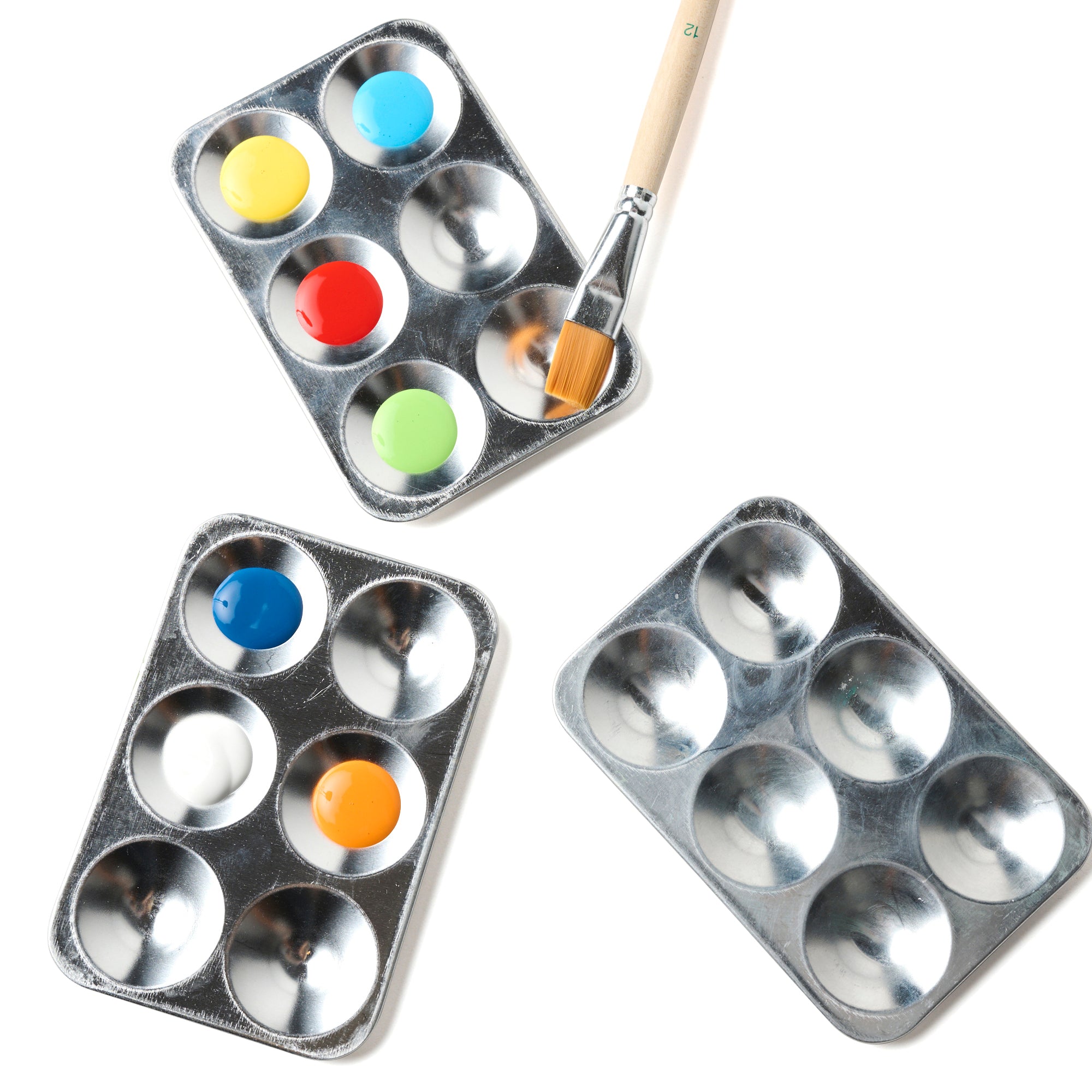 Elseware Unplug aluminum paint palettes with vibrant watercolor and acrylic paints in primary colors, alongside a wooden-handled paintbrush. Featuring six deep wells, these lightweight, eco-friendly palettes are perfect for mixing and blending colors for creative painting projects.