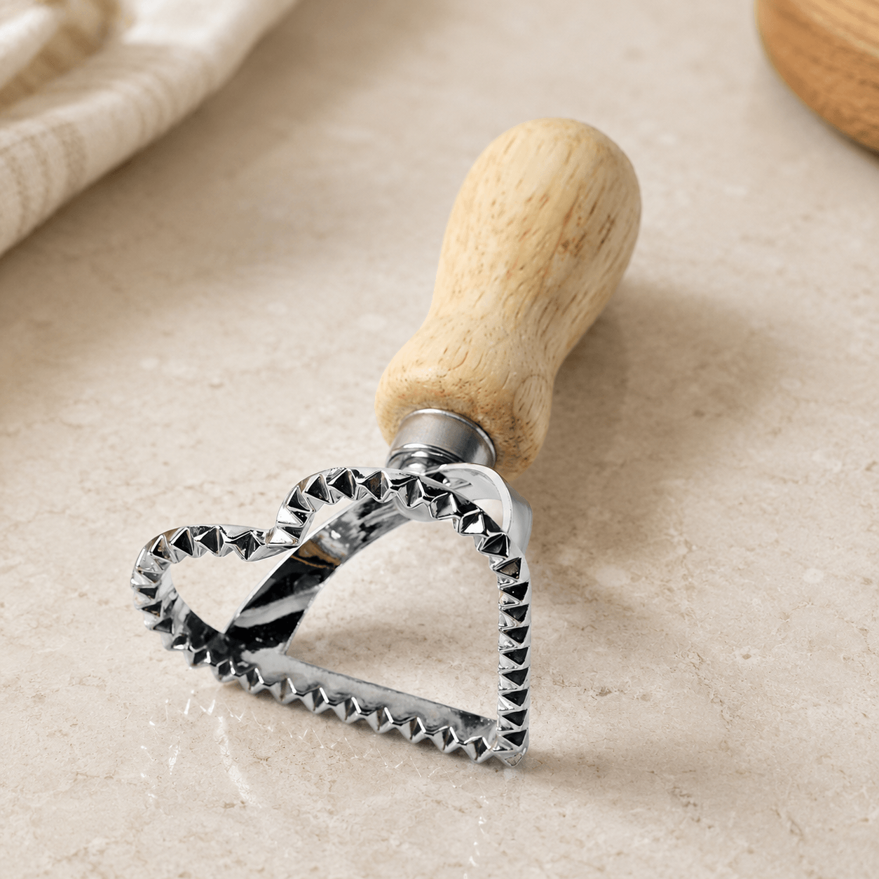 Heart shaped eco-dough cutter sitting on a counter top