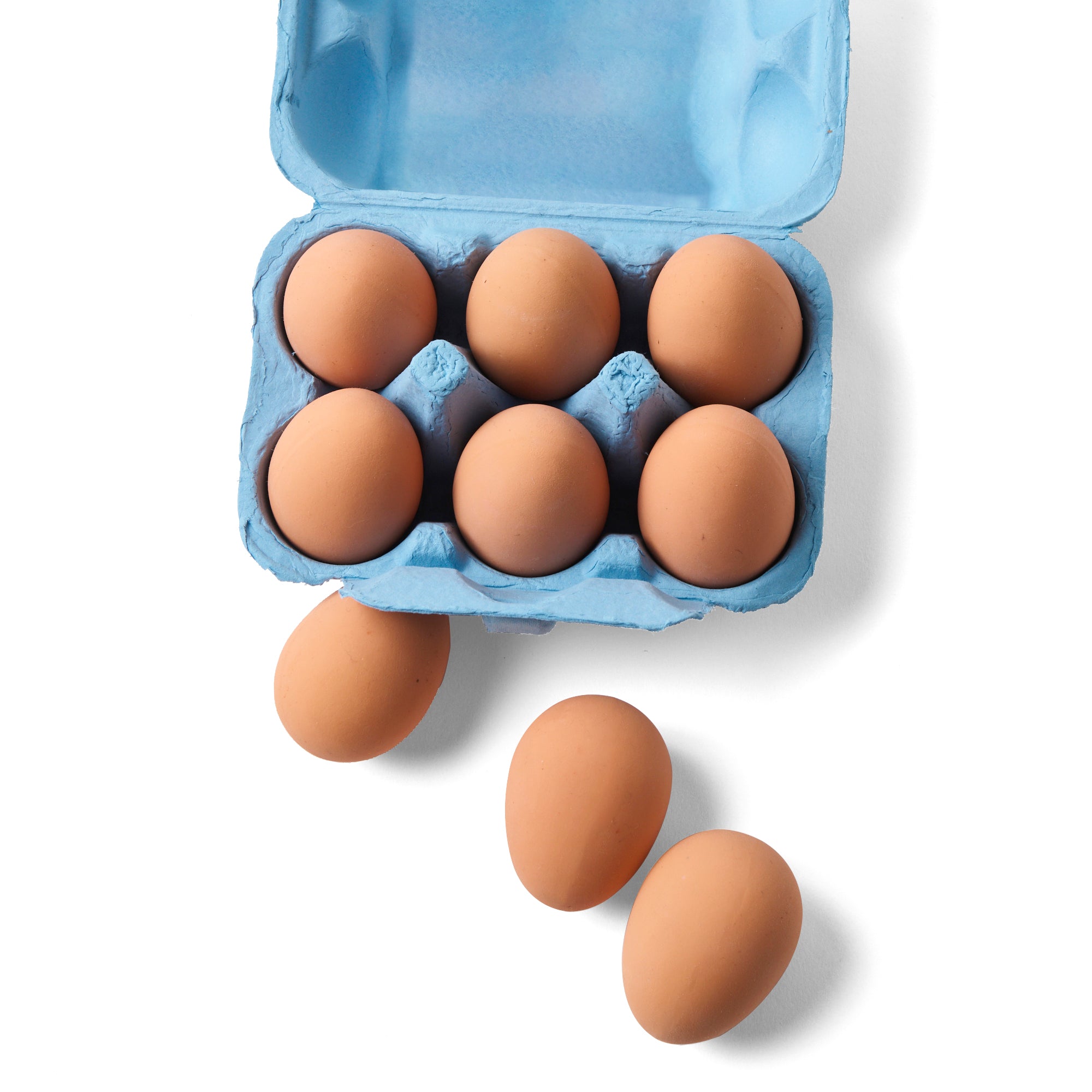 Open blue egg carton filled with eight realistic rubber eggs, with three more bouncy eggs scattered outside on a white background.