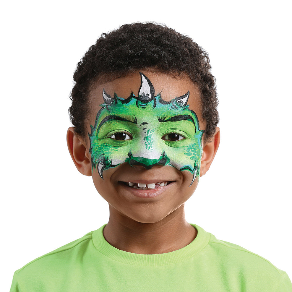 A young boy with short curly hair and a bright smile wears Elseware Unplug’s eco-friendly face paint, transformed into a fierce green dragon. His face is covered in vibrant green shades with black detailing, white highlights, and textured scales for a bold, mythical look. Horn-like accents above his eyebrows and a dragon snout around his nose complete the design. Elseware Unplug’s non-toxic, earth-friendly face paint offers safe, easy-to-use, and washable colors for creative play and imaginative transformat