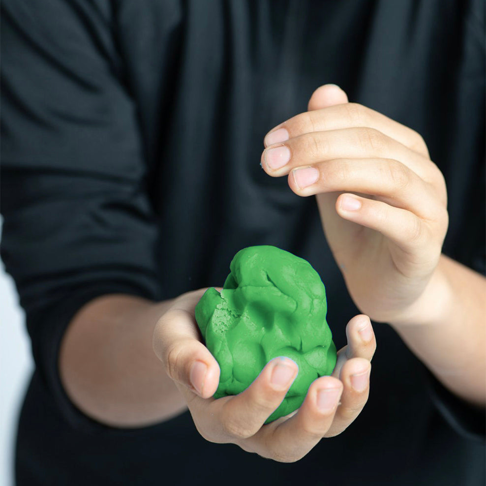 Close-up of hands squeezing Elseware Unplug Eco-Dough, highlighting its soft, moldable texture. This all-natural, non-toxic dough is perfect for sensory play and creative expression, providing a satisfying tactile experience for kids and adults alike.