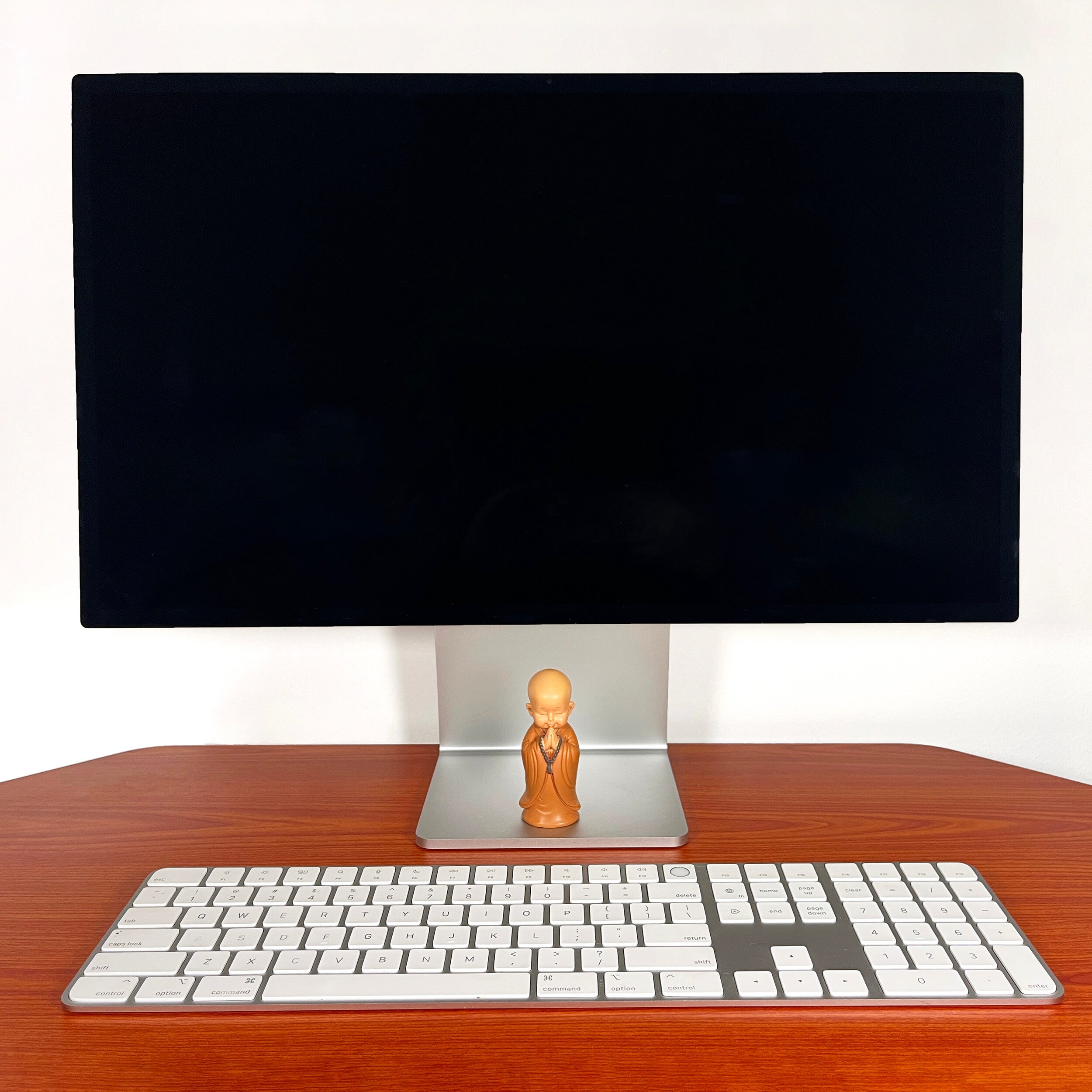Computer monitor with keyboard on a wooden desk with monk elseware unplug