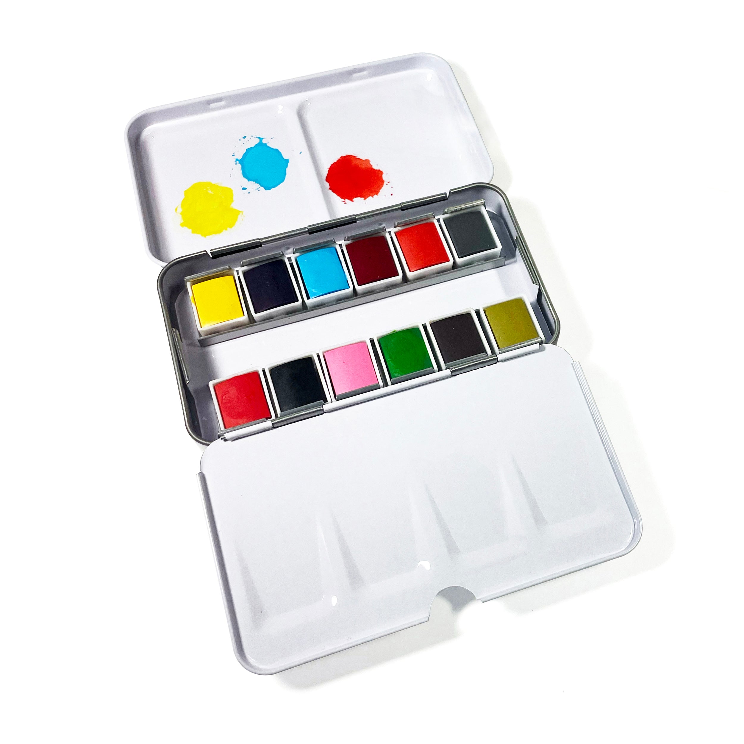 An open metal watercolor palette from Elseware Unplug, featuring twelve vibrant watercolor pans and a built-in mixing tray, ideal for creative painting on the go.