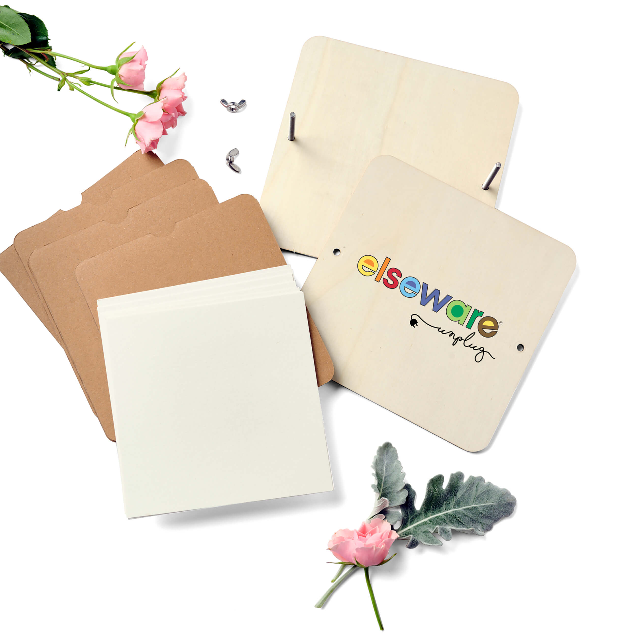 Complete Elseware Unplug flower press kit showing wooden plates, cardboard, blotter paper, bolts, and fresh flowers ready for pressing