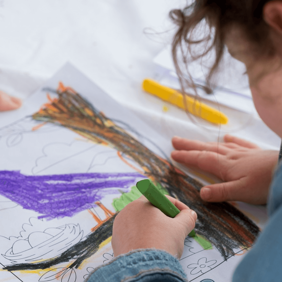 child using elseware unplug beeswax crayons on coloring sheet of a bird