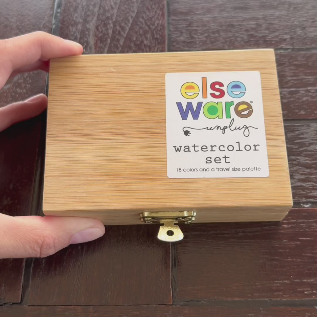 Artist painting colorful hot air balloons with Elseware Unplug watercolors from a bamboo case