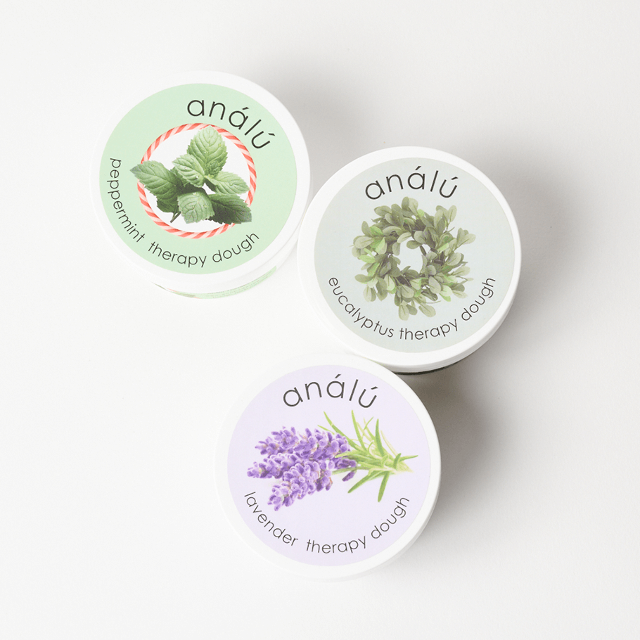 Three Analu Therapy Dough tins in Peppermint, Eucalyptus, and Lavender scents arranged on a white background.